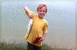 Morgan Herring of Fredericksburg, Va.,  who is visiting his Grandmother in 
Ocean Pines, proudly shows off a nice size Bass after practicing skills he 
acquired in the Ocean Pines Anglers Club 2006 