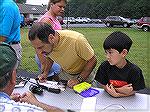 Adult and youngster check out tackle at the 6/26/2004 Ocean Pines Anglers Club Teach A Kid to Fish Day.