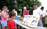 Youngster looks over the fishing lure display ay the Ocean Pines Anglers Club's Teach A Kid To Fish Day on 6/26/2004.