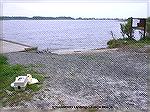 Strawberry boat launch area in the Assawoman Wildlife Area near Bethany, DE.  Site has a dock and ramp for power boats and an adjacent sandy beach strip suitable for canoes/kayaks.