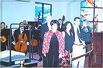 Maestro Don Buxton is shown accepting the new orchestra podium purchased by donations given in memory of Horatio[Rash] Jones. With him are Lydia Jones and her family.