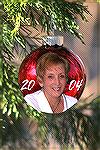 I took a red Xmas tree ball outside and hung it on a evergreen tree in my front yard and took a picture of it.  In my computer, in PhotoShop, I then added a picture of my wife, Mary Lou, and the year 