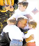 Jack Barnes III shown greeting his children Daniel, Luke, and Grace on return from mission Iraqi Freedom. Major Barnes is pilot of KC-135 refueling tanker for the Pa. Air National Guard in Pittsburgh,
