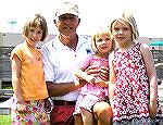 Proud granddad Bill Rakow poses with his three granddaughters while taking in the 2005 Ocean Pines Boat Parade.