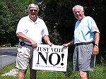 Al Bogdon (left), Treasurer of the STOP (Stop Taxing Ocean Pines) group, and group spokesman Marty Clarke plant the first "Vote NO" sign in front of Clarke's home on July 11, 2005.