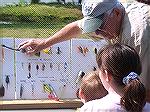 Ocean Pines Anglers club member Charlie Herpen shows types of lures to young anglers during 2005 Teach-A-Kid To Fish Day.
