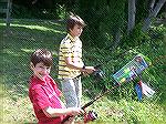 Ocean Piner Phillip Laminos [top] wets a line while younger brother Yanni elects to keep directions and lures attached to the rod for quick reference during Teach A Kid to Fish Day 2005.