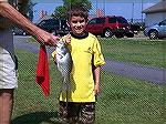 Young angler Noah Lara surprises the crowd by pulling in a 14 1/2" crappie from the south pond during the Ocean Pines Anglers Club 2005 Teach-A-Kid to Fish Day.