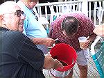 Charlie Herpen and John Henglein hold bucket as Walt Boge offers Flounder a beer after OP Anglers Club first Flounder Flurry event. 9/23/05 