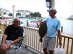 Bud Heim, proud winner of the first annual OP Anglers Club Flounder Flurry, displays his 23&quot; doormat to an equally impressed Charlie Herpen at the Yacht Club bar. 9/23/05 