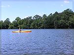 A kayaker on Johnson Pond in Salisbury.  (For use in a kayak trip report 8/25/2005)