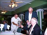 Charlie Herpen tears off tickets while Walt Boge collects money from OP Angler Bob Derby at 2005 Ocean Pines Anglers Club dinner at Embers restaurant.