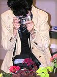 A member of the Ocean Pines Camera Club gets a photo of a flower at the Worcester County Garden Club show at the Ocean Pines Library on 10/10/2005.  Photo with an Olympus C-750 camera set for ISO 200,