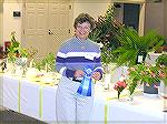 Lynn O'Keefe poses with her prize winning flower at the Worcester County Garden Club show at the Ocean Pines Library Oct. 10, 2005.
Photo with an Olympus C-750 camera set for ISO 200, F/2.8, 1/50 sec