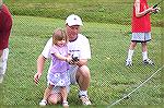 Ashley Moran gets casting lesson from her Dad Todd at the Ocean Pines Anglers club annual Teach A Kid To Fish Day.