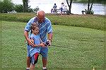 OP Angler John Jewer gives some casting tips to Ken Goubran of 
New York who was visiting his grandmother in Ocean Pines. The event was the Ocean Pines Anglers Club annual Teach A Kid To Fish Day.