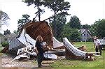 What happened after a steeple that was being lifted by crane to the top of a church on Deal Island slipped from the securing straps and came crashing down on the roadway. Fortunately no one was injure