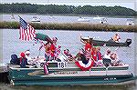 The Jerry Gray Family boat exhibits a patriotic theme with a generational twist in the OP Boat Clubs annual Boat Parade. Family members ranged in age from 7 to Grandma in the stern who is 92 years you
