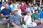 Dolores Pike, well known writer for the Courier newspaper, enjoys a break at the Shorebirds baseball game on an outing with the Community Church Of Ocean Pines. Dolores is seated between husband and s