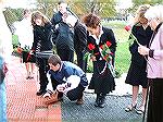 Benjamin Suplee lays the paver for his father, Dan Suplee while family looks on.  Ocean Pines Veterans' Memorial 10-28-06