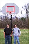 Mike Hindi and Jamie Shaffer stand under newly installed basketball backboard at Community Church of Ocean Pines. The project was successful thanks to a whole raft of folks that pitched in including A