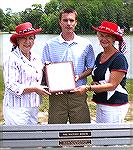 Veterans Memorial Co-chairman Roseann Bridgman and Sharyn O'Hare presenting an appreciation plaque to Craig Davis, owner of Taylors Neighborhood Restaurant.  Mr. Davis recently endowed the Waiting Ben