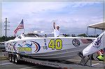 Disabled Navy vet and offshore powerboat driver Gino Marrone waves from the deck of his offshore racer YOU'RE IN COMMAND. The boat boasts twin 525HP engines and is partnered with the United States Coa