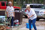 Don Messina exhibits subdued restraint as wife Deb attempts to figure out how rod & reel work in casting contest at OP Anglers Club picnic at White Horse Park..