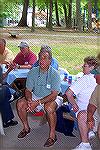 Ocean Pines Angler club member Bill Bellistri takes a well deserved break after overseeing the food at the Clubs annual picnic in White Horse Park. Joan Mullins looks suspiciously at the Juice Boxes o