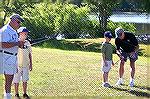 Angler Club members George Wood and Bill Bundy help a couple of budding young anglers with their casting skills.