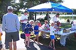 Dick and Marianna Nieman with assistance from Jane Wood check in 3 of the close to 100 young anglers that attended the Ocean Pines Anglers Club, Teach A Kid To Fish day at the South Pond. Counting ang