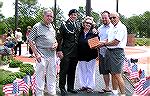 Sergeant R. J. Sturgil at Veterans Memorial ceremony for paver placement. Pictured with Sturgill are his mom, dad, and brother. Veterans Memorial representative Bill Rakow holds brick paver to be plac