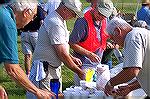 Ocean Pines Angler Club members Charlie Herpen, Bob Gilbert and Frank Sabota attack the enviable job of separating the worms for the young anglers at the Ocean Pines Anglers Club, Kids Fishing Tournam