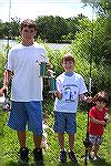 L/R   Charlie McCairns, Joey Nibali and Vance Jenkins show their prizes for winning the "Largest Fish" category in their respective age group. Young Vance, in the 8 & under age group showed that age i