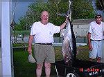 Dennis Escher stands by 53&quot; 99 1/2 lb tuna he caught in the waters off of Ocean City.