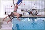 Image from Grand Opening of the Ocean Pines Sports Core indoor pool enclosure on 10/13/2007. Director Reid Sterrett and son jump into pool.