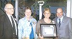 An American Tradition Certificate of Appreciation is presented to the Shepherd's Nook of the Community Church at Ocean Pines.  Accepting the honor are Reverend P. Thomas McKelvey, Joleen Killinger, Lo