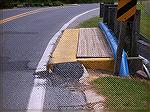 This is a photo of maintenance modification done to reduce the risk of a car tire hitting the "hard" or "square" curb edge that is right next to the roadway.  Asphalt has been ramped up to make the sq