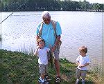 4 year old Kevin Young,from Buenos Aires, Argentina shows his grandfather Phillip Young of Berlin that he knows how to catch the big ones at the Ocean Pines Anglers club..Teach A kid To Fish day at th