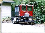 What is it, a truck, trailer, train or plane?

At quick glance, this thing first looks like a truck. A fellow in South OP keeps this trailer on his driveway. The vehicle parked on the trailer is a w