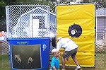Reverend Tom McKelvey finds out that a little boy has a strong arm at the dunking booth and heads into the water