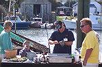 Jeffrey Phillips of the famous Phillips family shucks oysters and serves up crab claws, all for free, at the first annual Harbor Day in W.Ocean City.