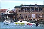 Bull On The Beach offshore powerboat race entry passes in front of another eating landmark. 