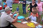 Officer John Chlada from Marylands Department of Natural Resources explains rules and regulations to aspiring young anglers at the Ocean Pines Anglers Club 2009 Teach A Kid To Fish event. The yellow w
