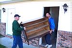 Dan and Lee, friends of Ocean Pines resident Mike Borland help move some of the 3 truckloads of furniture donated by Mike Borland into a young mothers apartment. Initially the mother, who is raising 2