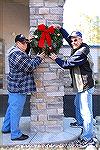 A couple of helpers busy hanging wreaths during the Ocean Pines Garden Club's &quot;Decorate the Pines&quot; event held on 12/1/09.  A number of members and helpers worked several hours to create and 