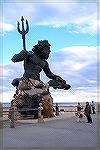 King Neptune bronze sculpture at entrance to Virginia Beach.Andrea Barnes and therapy dog King look on.