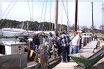 Skipjack crew prepares to unload the days work as oyster buyer seen sitting way down at the end of the dock keeps a watchful eye. Oyster on this day in March were selling for $21 a bushel.