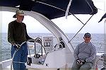Captain Dr. John Bower keeps a watchful eye on Captain in Training John Wells as he navigates the waters of the Chesapeake Bay. 