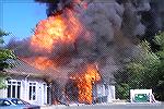 Photo of the Purnell Center engulfed in flames. The office complex on RT 50 near Riddle Farms housed the Merrill Lynch office among others.